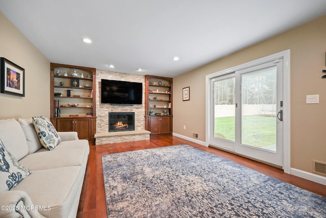 41 Revere Pl, Freehold, NJ 07728 - living area with wood finished floors, a stone fireplace, baseboards, recessed lighting, and built in shelves