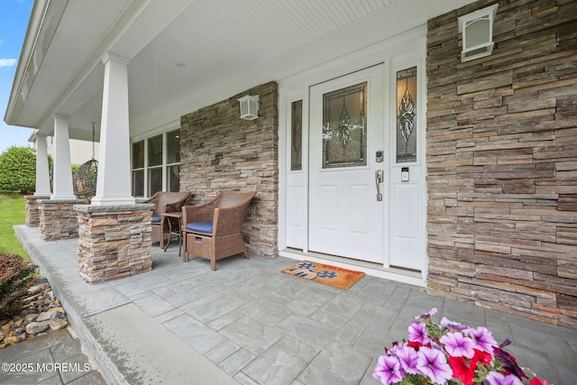 41 Revere Pl, Freehold, NJ 07728 - view of exterior entry featuring covered porch and stone siding