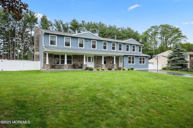 41 Revere Pl, Freehold, NJ 07728 - view of front facade with a chimney, covered porch, and stone siding