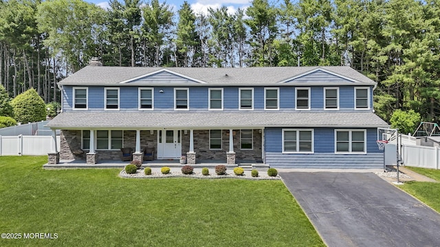 41 Revere Pl, Freehold, NJ 07728 - view of front of property featuring covered porch, a chimney, asphalt driveway, a shingled roof, and stone siding
