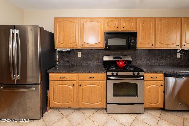 6 Manitoba Ct, Toms River, NJ 08757 - kitchen with appliances with stainless steel finishes, light tile patterned floors, dark countertops, and tasteful backsplash