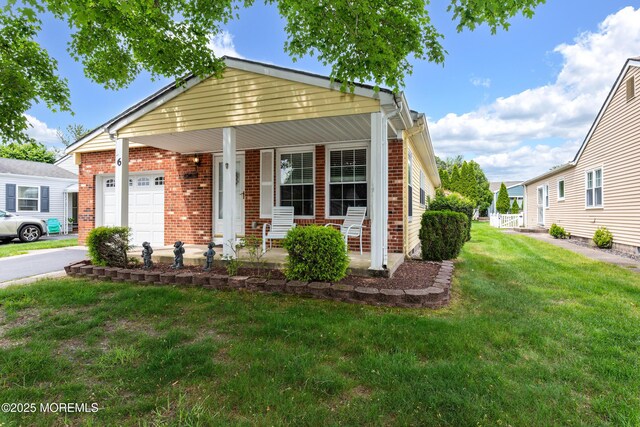 6 Manitoba Ct, Toms River, NJ 08757 - view of front of property with brick siding, covered porch, a front lawn, an attached garage, and driveway
