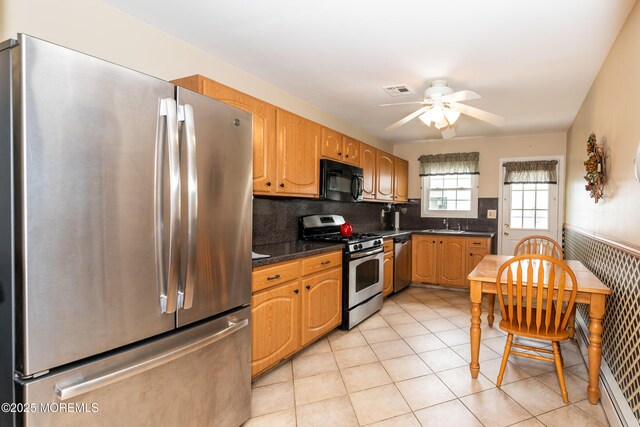 6 Manitoba Ct, Toms River, NJ 08757 - kitchen with appliances with stainless steel finishes, ceiling fan, dark countertops, light tile patterned flooring, and a sink