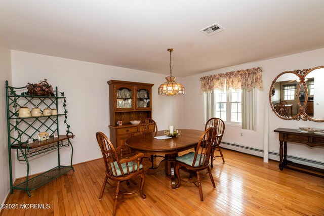 6 Manitoba Ct, Toms River, NJ 08757 - dining room featuring light wood-style floors and a baseboard heating unit