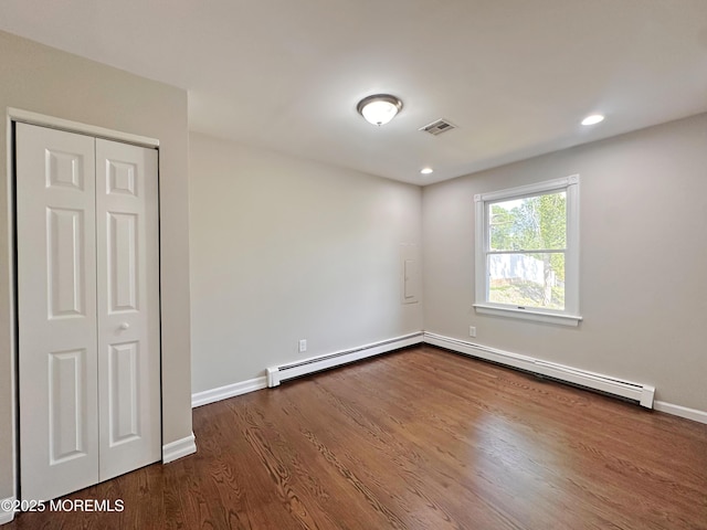 405 Old Bridge Rd, Brielle, NJ 08730 - unfurnished room with a baseboard heating unit, dark wood-style floors, a baseboard radiator, baseboards, and recessed lighting