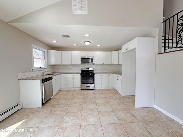 405 Old Bridge Rd, Brielle, NJ 08730 - kitchen featuring stainless steel appliances, baseboard heating, light stone countertops, tasteful backsplash, and white cabinets