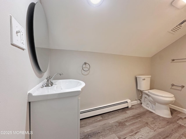405 Old Bridge Rd, Brielle, NJ 08730 - bathroom with a baseboard heating unit, vaulted ceiling, vanity, wood finished floors, and toilet