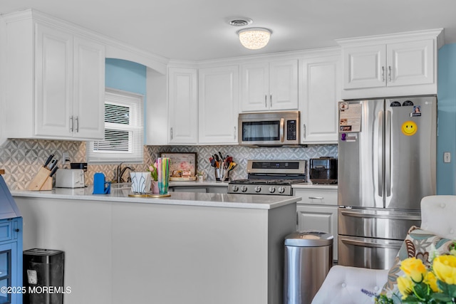 81 Encinitas Dr, Toms River, NJ 08757 - kitchen featuring appliances with stainless steel finishes, white cabinets, light countertops, backsplash, and a peninsula