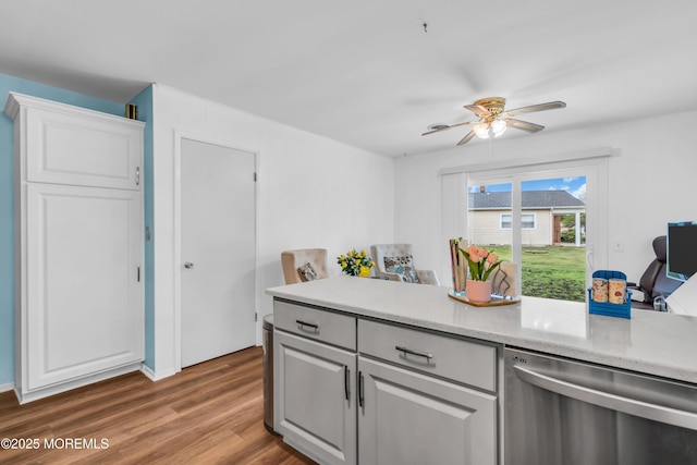 81 Encinitas Dr, Toms River, NJ 08757 - kitchen featuring stainless steel dishwasher, light countertops, wood finished floors, ceiling fan, and white cabinetry