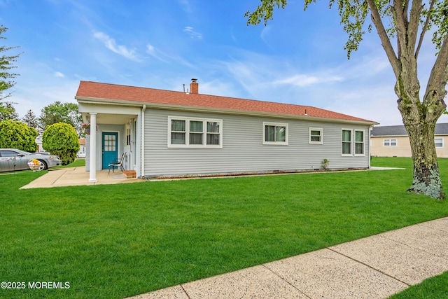 81 Encinitas Dr, Toms River, NJ 08757 - view of front of home featuring a patio area, a front yard, and a chimney