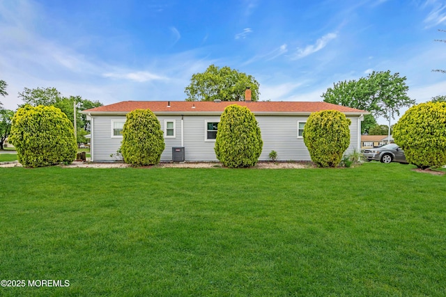 81 Encinitas Dr, Toms River, NJ 08757 - back of house featuring a lawn, central air condition unit, and a chimney