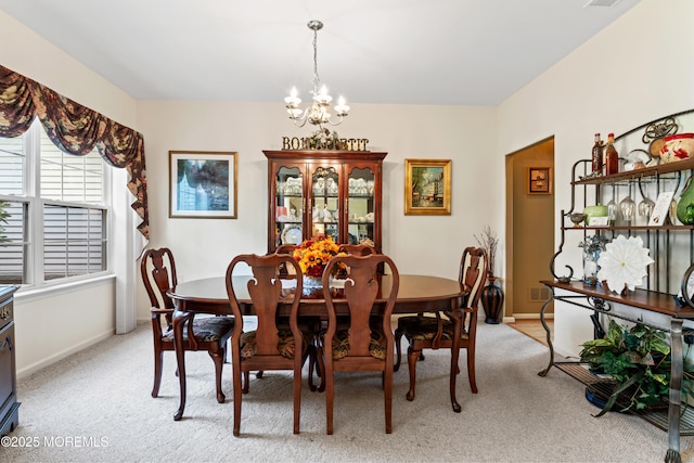67 Isabella Dr, Manchester, NJ 08759 - dining area with a chandelier, light colored carpet, and baseboards