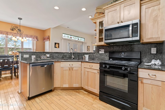 67 Isabella Dr, Manchester, NJ 08759 - kitchen with stainless steel appliances, light brown cabinets, a sink, a peninsula, and recessed lighting