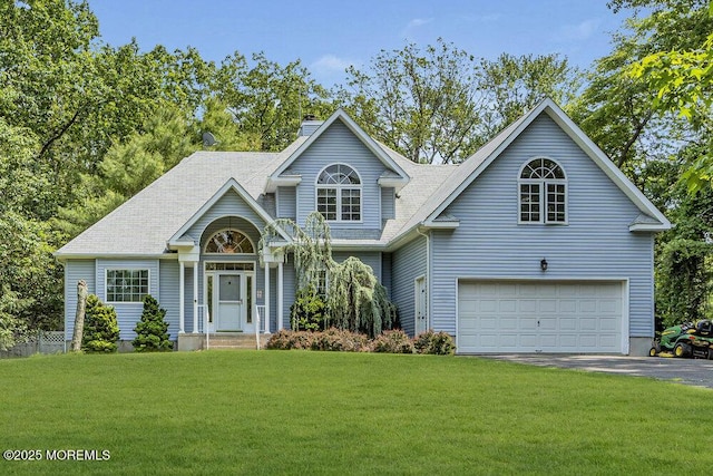 9 Rachel Ct, Jackson, NJ 08527 - traditional-style house with driveway, a front lawn, an attached garage, and a chimney