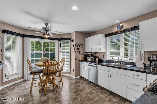 9 Rachel Ct, Jackson, NJ 08527 - kitchen with stainless steel dishwasher, a sink, a ceiling fan, baseboards, and dark countertops