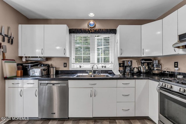 9 Rachel Ct, Jackson, NJ 08527 - kitchen with appliances with stainless steel finishes, a sink, white cabinetry, dark countertops, and wood finished floors