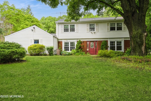 36 Merion Dr, Manalapan, NJ 07726 - colonial-style house with a front yard and brick siding