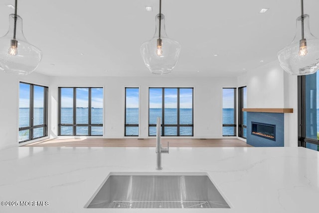 2 Brant Dr Lot 5.01, Atlantic Highlands, NJ 07716 - kitchen with open floor plan, a glass covered fireplace, stone countertops, a water view, and hanging light fixtures
