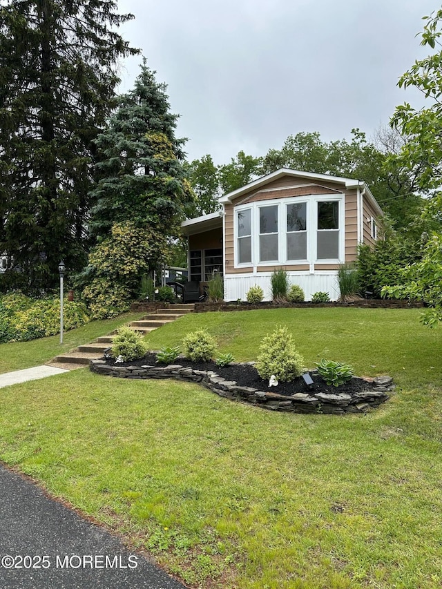 138 Oak Dr, Manchester, NJ 08759 - view of front facade with a front lawn