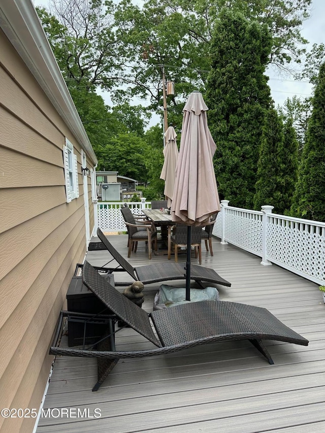 138 Oak Dr, Manchester, NJ 08759 - wooden terrace with outdoor dining space and view of wooded area