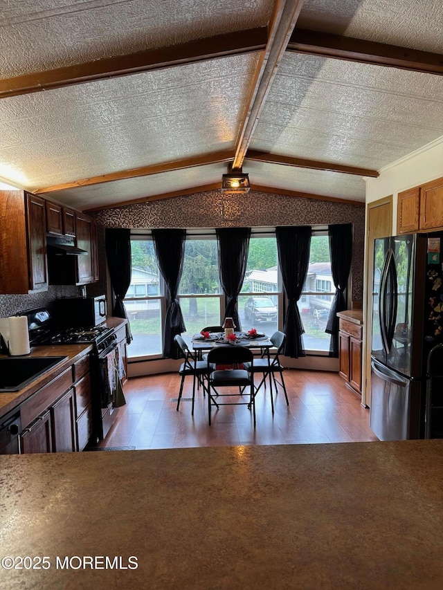138 Oak Dr, Manchester, NJ 08759 - kitchen with freestanding refrigerator, light wood-type flooring, vaulted ceiling, extractor fan, and a sink