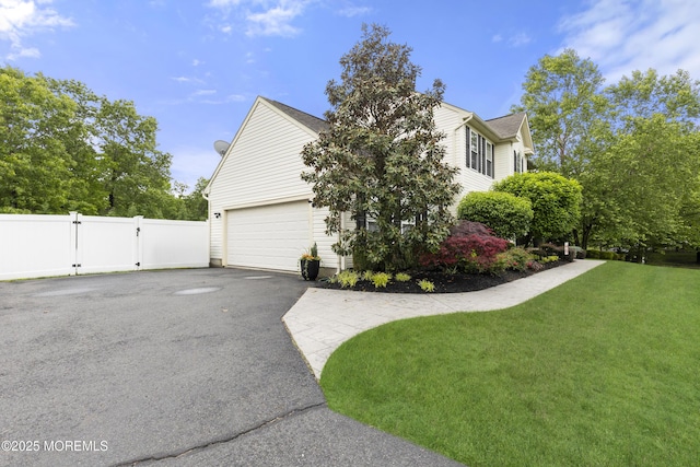 1 Kennedy Ct, Jackson, NJ 08527 - view of side of property featuring a garage, a gate, and asphalt driveway