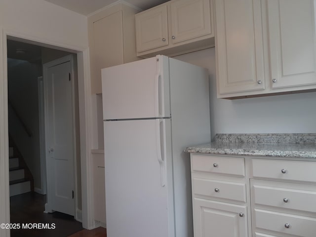 133 3rd Ave, Neptune City, NJ 07753 - kitchen featuring freestanding refrigerator, white cabinets, and light stone counters