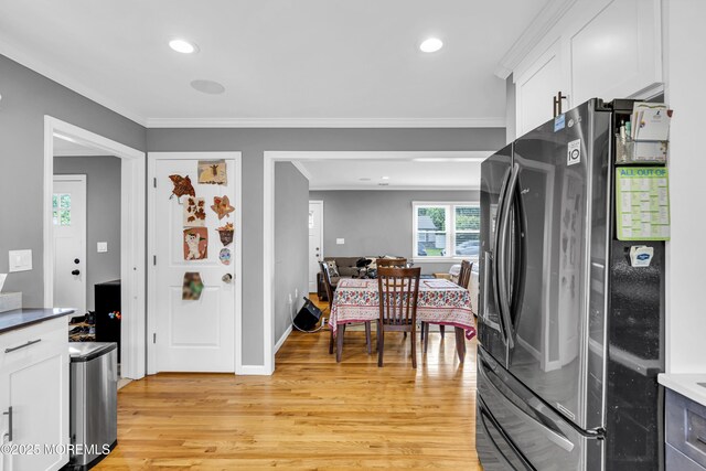 18 Delaware Ave, West Long Branch, NJ 07764 - kitchen featuring stainless steel fridge with ice dispenser, light wood-style floors, white cabinetry, ornamental molding, and recessed lighting