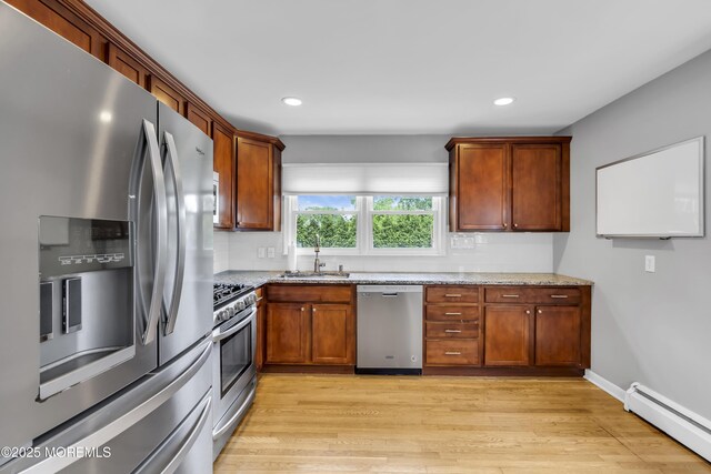 20 Delaware Ave, West Long Branch, NJ 07764 - kitchen with stainless steel appliances, baseboard heating, light stone countertops, light wood-style floors, and recessed lighting