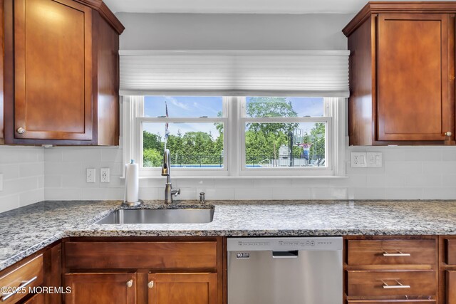 20 Delaware Ave, West Long Branch, NJ 07764 - kitchen with dishwasher, decorative backsplash, light stone countertops, and brown cabinetry