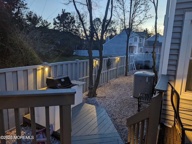 56 Turnberry Cir Unit 138, Toms River, NJ 08753 - deck at dusk with a fenced backyard and central air condition unit
