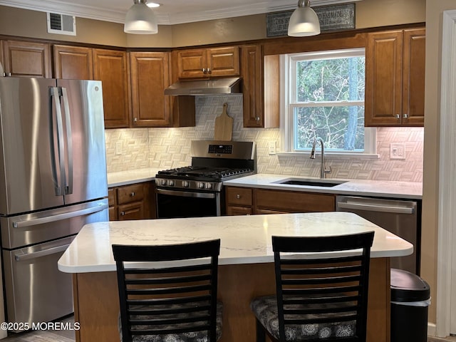 56 Turnberry Cir Unit 138, Toms River, NJ 08753 - kitchen with stainless steel appliances, under cabinet range hood, a sink, tasteful backsplash, and pendant lighting