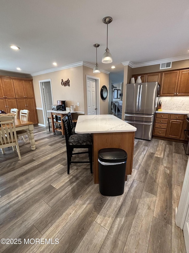 56 Turnberry Cir Unit 138, Toms River, NJ 08753 - kitchen with freestanding refrigerator, dark wood-style flooring, a kitchen island, recessed lighting, and brown cabinets