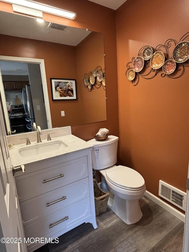 56 Turnberry Cir Unit 138, Toms River, NJ 08753 - bathroom with toilet, wood finished floors, vanity, and baseboards