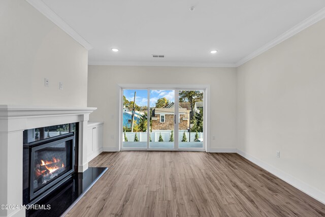 34 Broad St Unit 306, Manasquan, NJ 08736 - unfurnished living room featuring ornamental molding, a high end fireplace, wood finished floors, baseboards, and recessed lighting