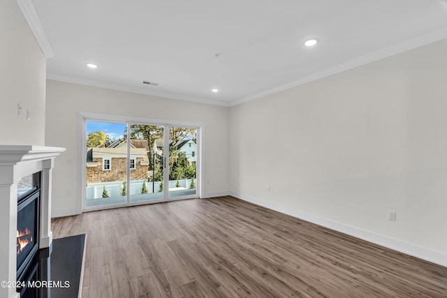 34 Broad St Unit 306, Manasquan, NJ 08736 - unfurnished living room featuring wood finished floors, a glass covered fireplace, baseboards, crown molding, and recessed lighting