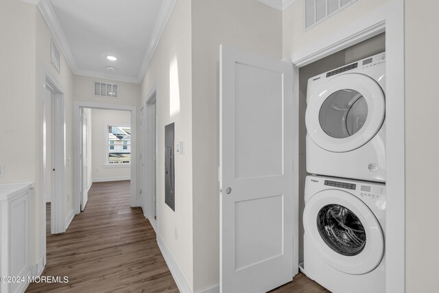34 Broad St Unit 306, Manasquan, NJ 08736 - laundry area with stacked washer and clothes dryer, crown molding, baseboards, wood finished floors, and electric panel