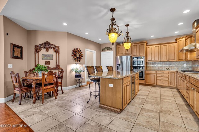 13 Cedar Tree Ln, Toms River, NJ 08753 - kitchen featuring appliances with stainless steel finishes, a kitchen island, baseboards, light stone countertops, and recessed lighting