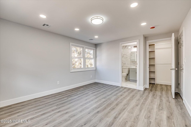 31 Smullen St, Sayreville, NJ 08872 - unfurnished bedroom featuring light wood-type flooring, recessed lighting, a walk in closet, baseboards, and ensuite bath