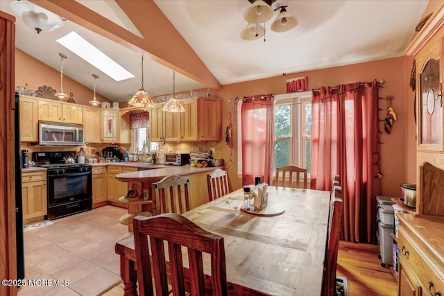 4 Calt Dr, Hazlet, NJ 07730 - dining area featuring a skylight, lofted ceiling, a ceiling fan, and light tile patterned floors