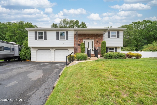 20 Sugarbush Rd, Howell, NJ 07731 - bi-level home with a garage, driveway, a front lawn, and brick siding