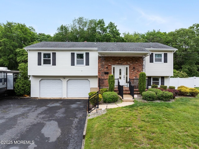 20 Sugarbush Rd, Howell, NJ 07731 - raised ranch with a garage, driveway, and view of wooded area