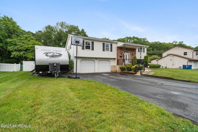 20 Sugarbush Rd, Howell, NJ 07731 - raised ranch with an attached garage, driveway, and brick siding