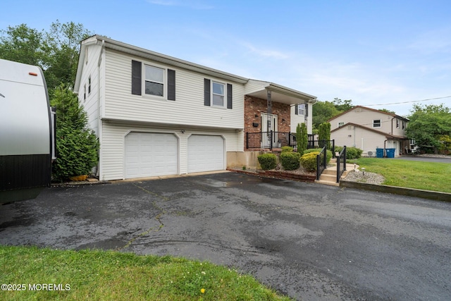 20 Sugarbush Rd, Howell, NJ 07731 - bi-level home featuring a garage and asphalt driveway
