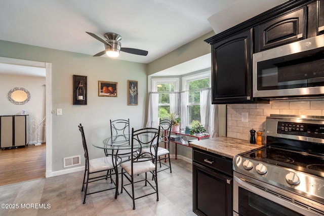 20 Sugarbush Rd, Howell, NJ 07731 - kitchen featuring stainless steel appliances, a ceiling fan, backsplash, baseboards, and dark cabinetry