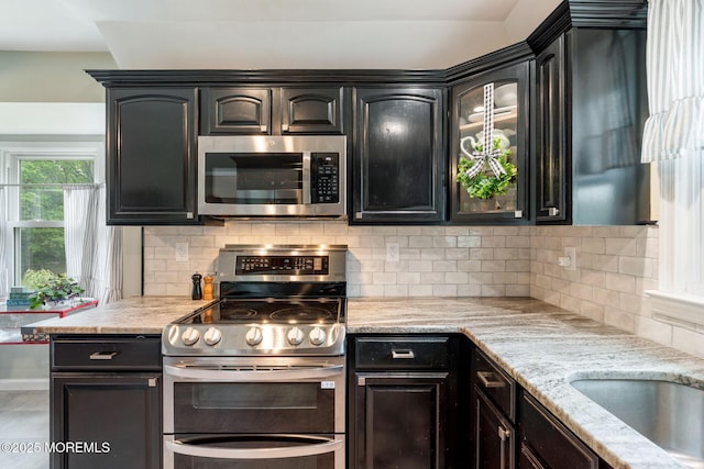 20 Sugarbush Rd, Howell, NJ 07731 - kitchen featuring stainless steel appliances, backsplash, light stone countertops, and glass insert cabinets