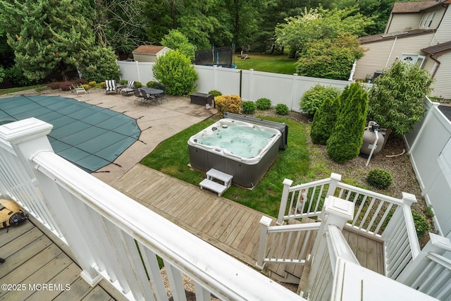 20 Sugarbush Rd, Howell, NJ 07731 - fenced backyard featuring a deck, a hot tub, a trampoline, and a patio area