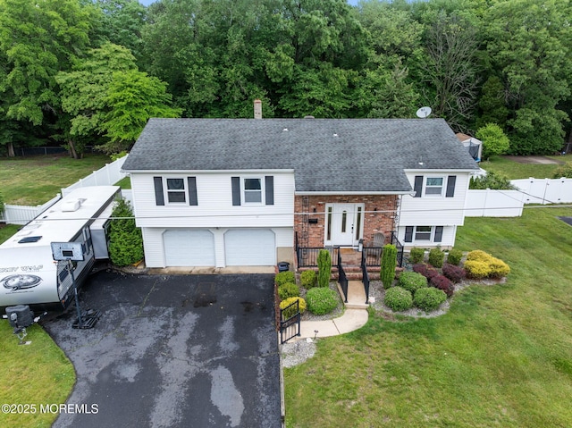 20 Sugarbush Rd, Howell, NJ 07731 - view of front of house with an attached garage, driveway, roof with shingles, and brick siding
