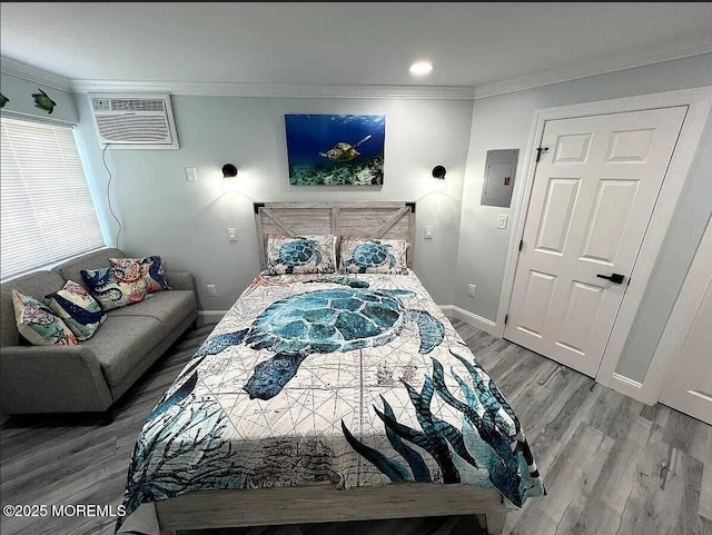 225 E Wildwood Ave # 323, Wildwood, NJ 08260 - bedroom featuring a wall mounted air conditioner, electric panel, ornamental molding, baseboards, and light wood-type flooring