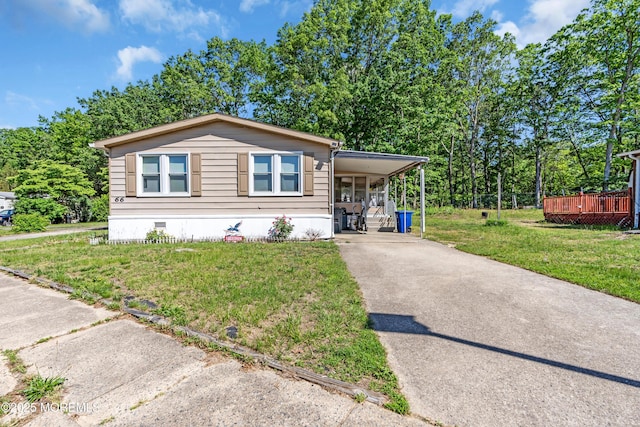 66 Douglas Dr, Jackson, NJ 08527 - manufactured / mobile home featuring driveway, crawl space, a front yard, and an attached carport